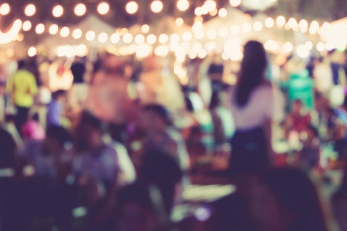 Blurred image of people at a night market.